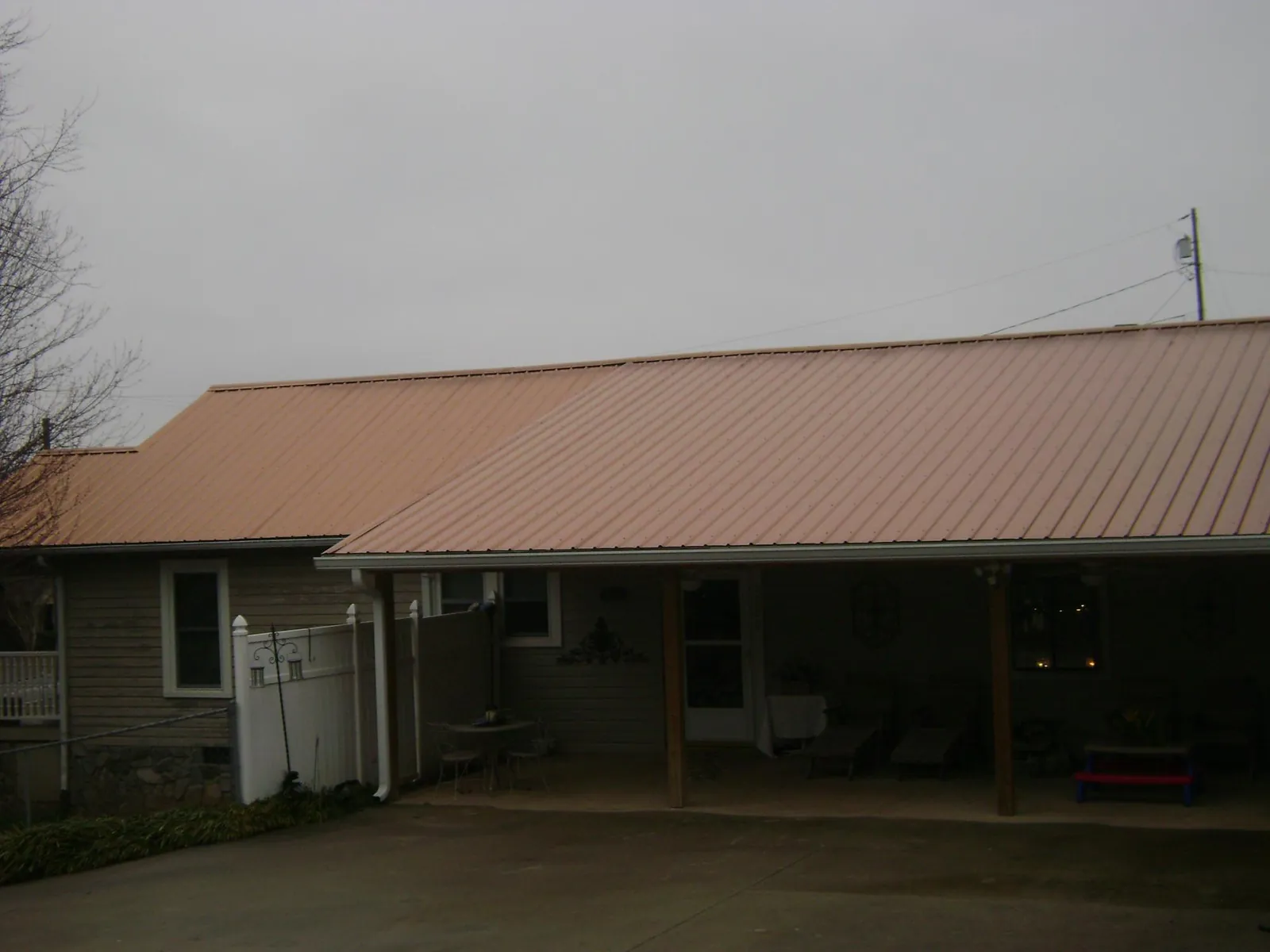Copper toned metal roof over a wide covered patio in Taunton